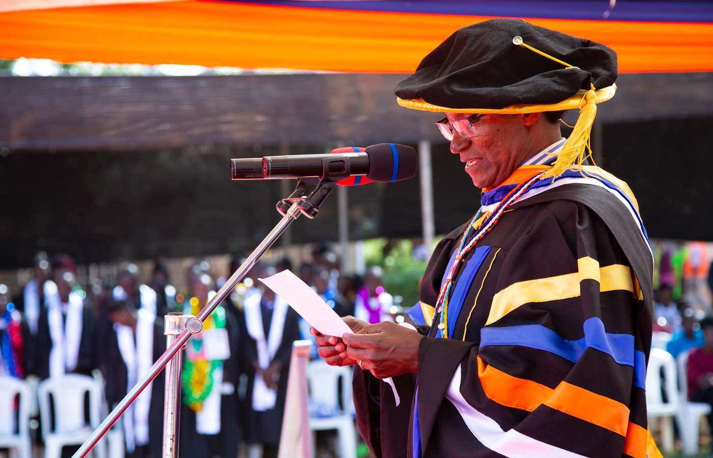Dr. Charles Mulli, founder of Mully Children's Family, addressing a Mully College graduation