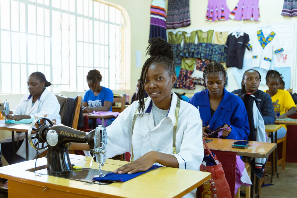 Fashion and design trainees working at sewing machines