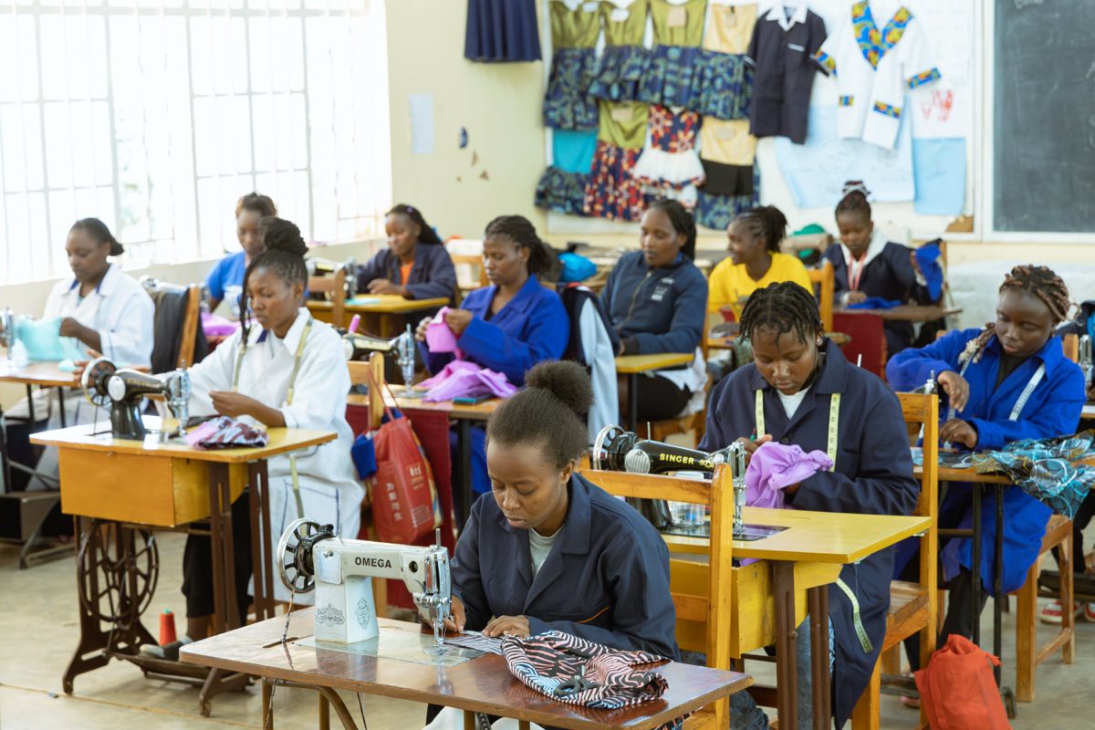 A fashion and design trainee finishing a garment