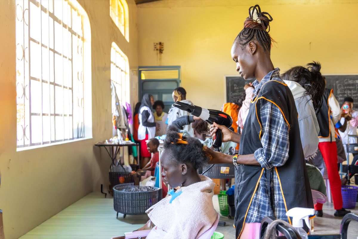Hairdressing trainees styling hair in the college salon
